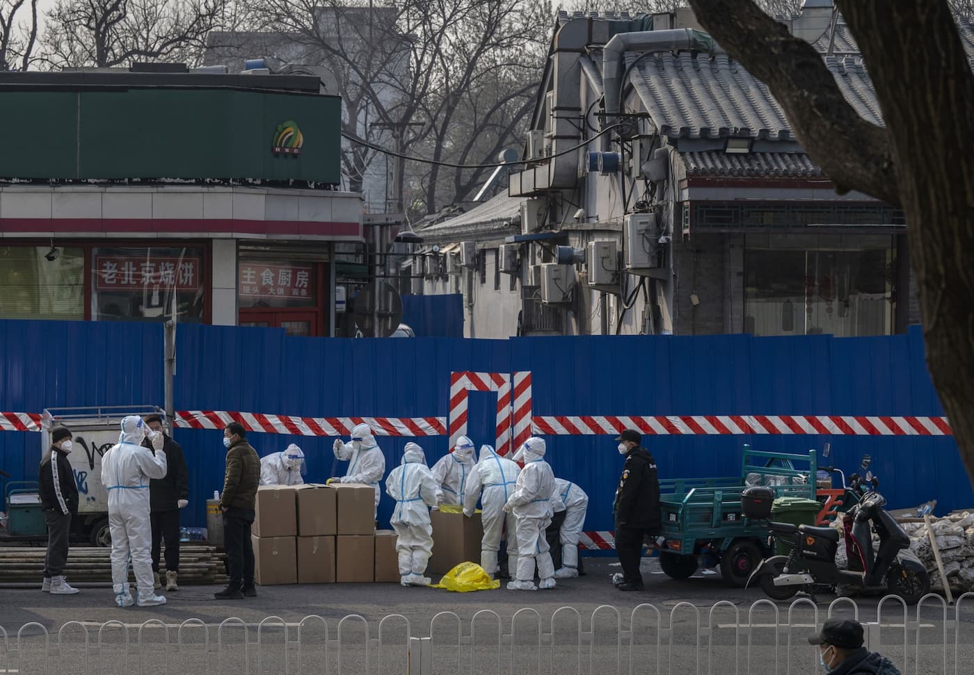 3月23日、北京で健康監視のために封鎖されたコミュニティの外で廃棄物を処理する作業員。写真家：Kevin Frayer/Getty Images AsiaPac